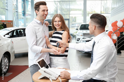 Young couple buying car in ...