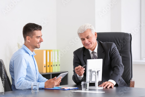 Elderly man consulting cust...