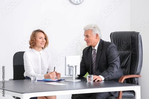 Elderly man consulting youn...