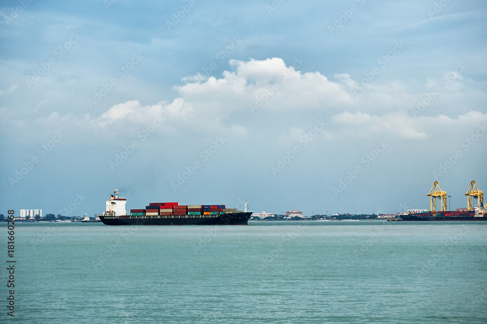 Fototapeta premium Cargo ship with containers near the port in Penang, Malaysia