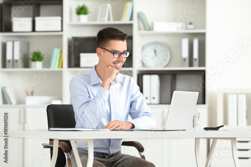 Wallpaper Mural Attractive man with laptop in office Torontodigital.ca