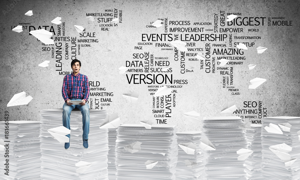 Attractive man sitting on pile of paper documents. Attractive man sitting on pile of paper documents.