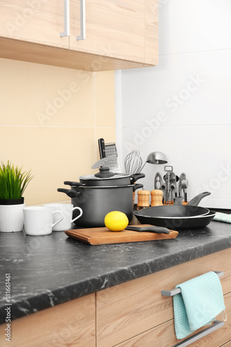 Different kitchen utensils on table in kitchen