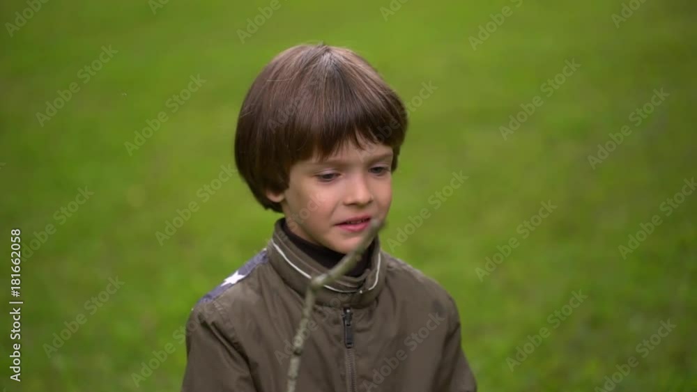 Close up portrait of a very cute young boy who catches soap bubbles. slow-motion Close up portrait of a very cute young boy who catches soap bubbles. slow-motion