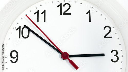 Closeup clock ticking showing three hours