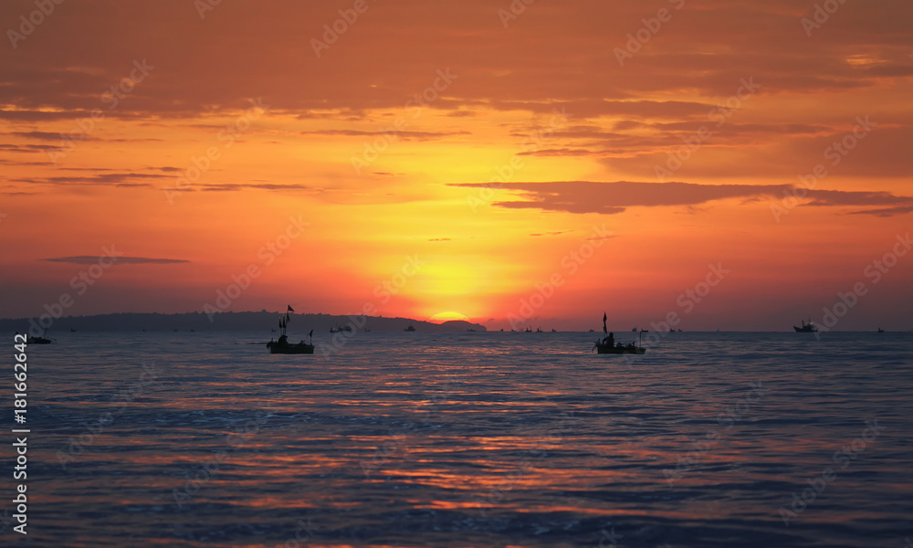  sea landscape with red sunset ,blue the sea and the silhouette of the fishing boats