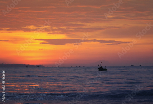 beautiful bright seascape red sunset , blue the sea and the silhouette of the fishing boats
