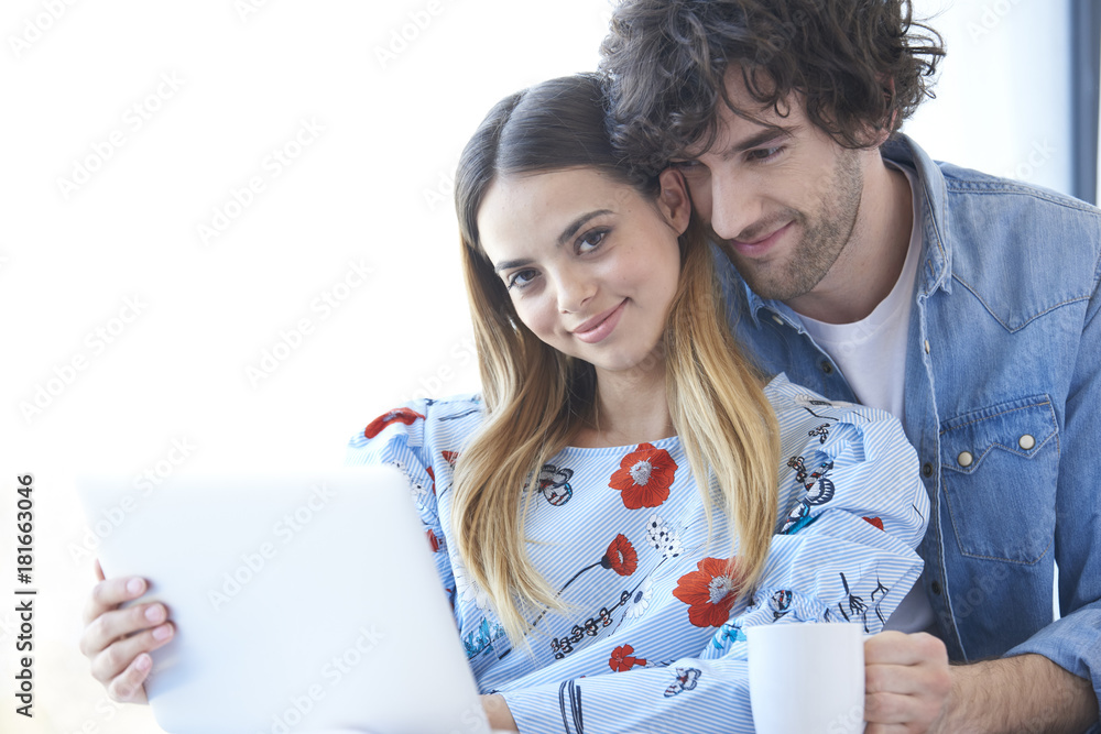 Enjoy spending time together. Young couple surfing on the net at home. Enjoy spending time together. Young couple surfing on the net at home.