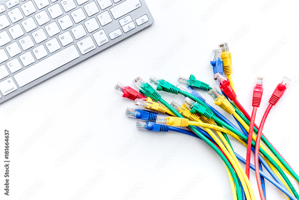 Network cables near keyboard on white background top view Network cables near keyboard on white background top view