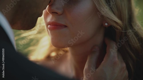 Lovers in a field at sunset.Couple in love against each other with closed eyes.