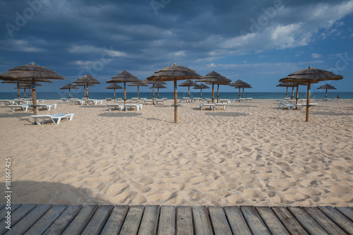 Rows of sun loungers and umbrellas on the beach.Tavira, Portugal © Radomir Rezny