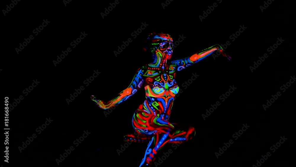 Beautiful young sexy girl in lingerie dancing with ultraviolet paint on her body. Girl with neon bodyart in color light. Beautiful young sexy girl in lingerie dancing with ultraviolet paint on her body. Girl with neon bodyart in color light.
