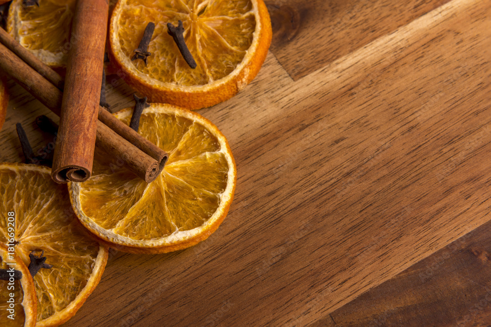 Dried orange slices on a wooden background arranged with cinnamon and anis Dried orange slices on a wooden background arranged with cinnamon and anis