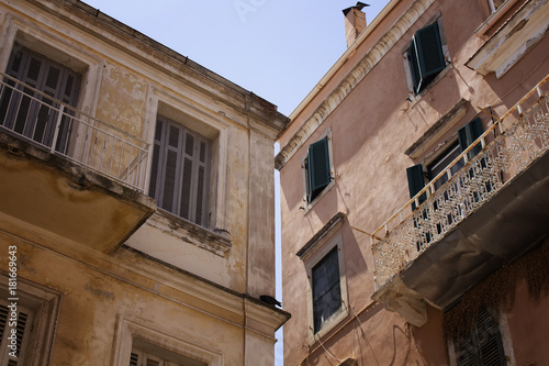 Old, historical buildings in Corfu (Kerkyra) town. It's an island of Greece’s northwest coast in the Ionian Sea. Cultural heritage reflects years spent under Venetian, French and British rule. © theendup