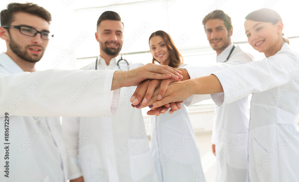 Doctors and nurses in a medical team stacking hands Doctors and nurses in a medical team stacking hands