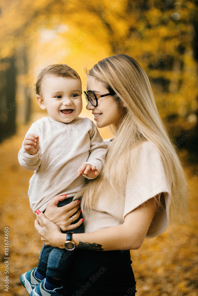 Young mother rising baby up Young mother rising baby up