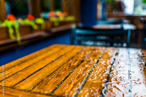 Wallpaper Mural Wet table closeup outside restaurant during heavy rain Torontodigital.ca