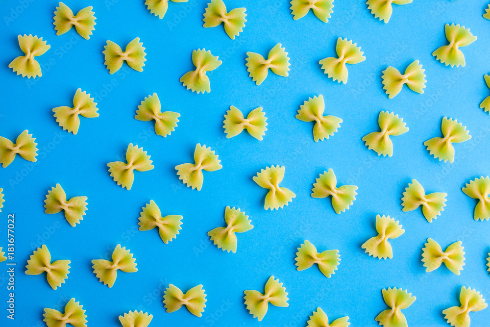 Pattern made of pasta on blue background. Flat lay. Minimal concept Pattern made of pasta on blue background. Flat lay. Minimal concept