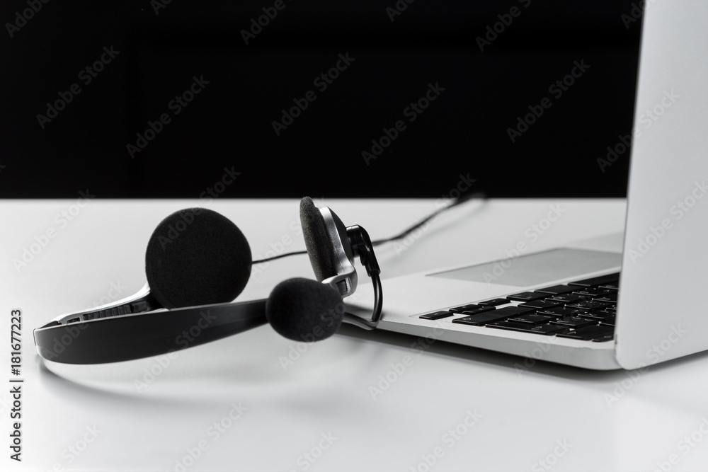 call center support concept. headset on keyboard computer laptop call center support concept. headset on keyboard computer laptop