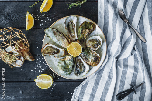 Wallpaper Mural Open wet oysters on a plate with lemon Torontodigital.ca