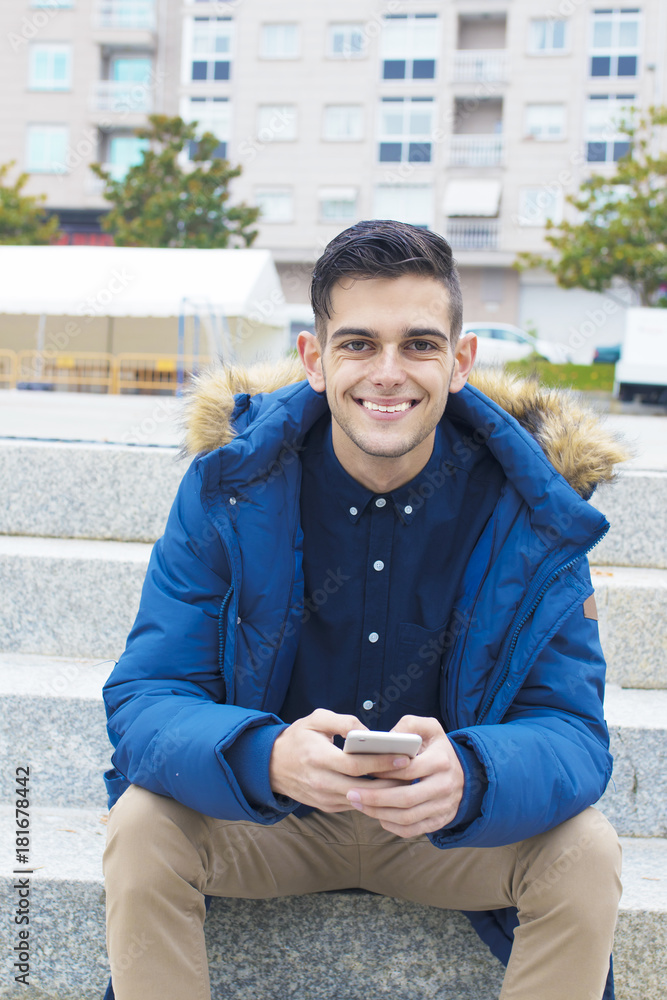 Obraz premium young adult with mobile phone on the stairs of the city