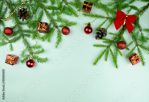  Christmas tree branches with cones, red balls and small presents, copy space