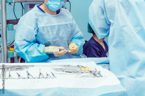 Close up hands of surgery assistant prepearing steralized surgical tools for surgery operation. Selective focus
