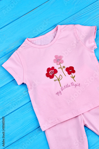 Toddler girl cute summer apparel. Organic cartoon t-shirt for baby-girl. Pink natural suit for child, top view. © DenisProduction.com