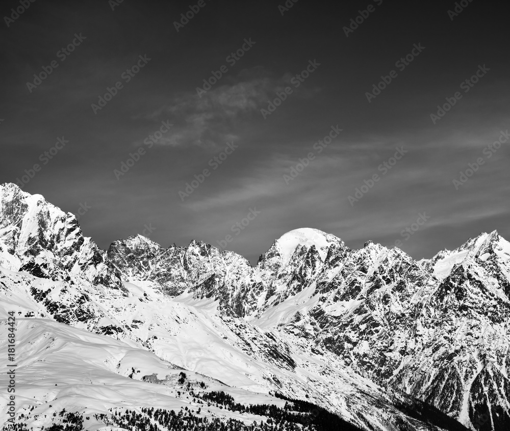Obraz premium Black and white snowy mountains in winter at sun day