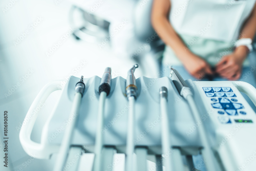 Dental instruments on the dental chair, closup photo - obrazy, fototapety, plakaty 
