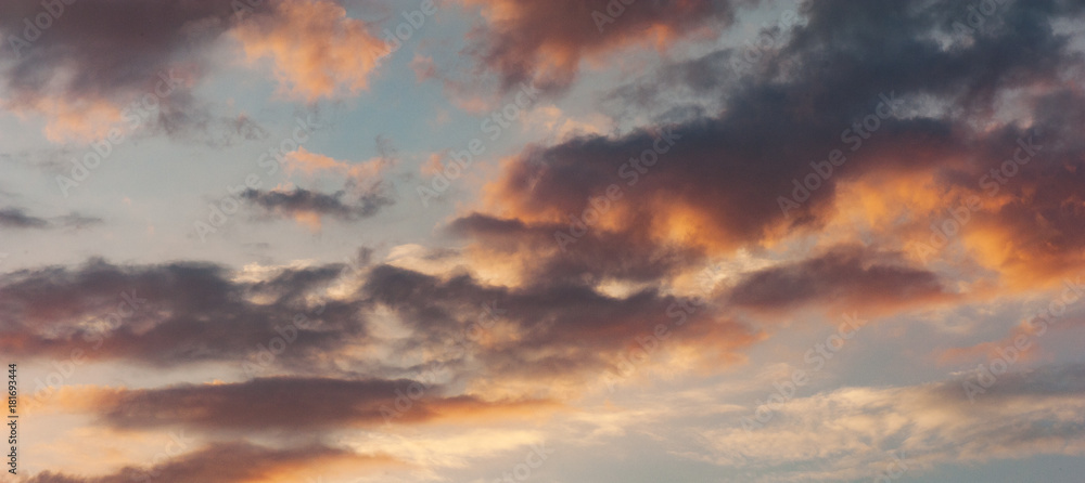 The panorama of the sky with couds at the sunset. Copy space