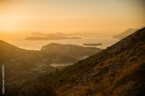 Sunset on the Adriatic sea with layers mountains on the horizon. Beautiful panoramic view of Dubrovnik, Croatia.