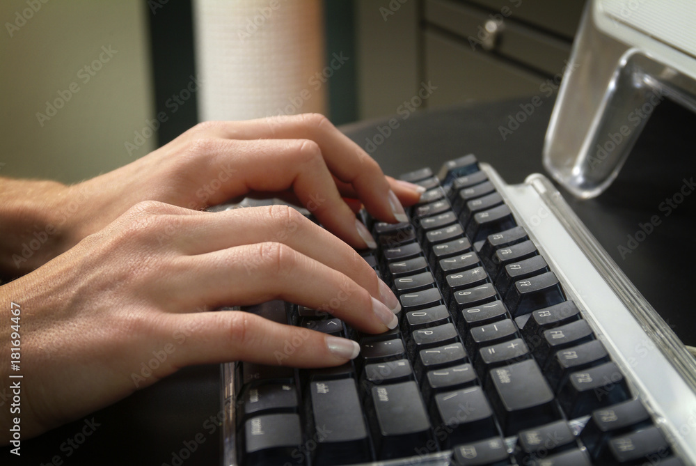 Woman's Hands Typing on Computer Keyboard. Closeup of a Woman's hands typing on a computer keyboard in an office or business situation. Woman's Hands Typing on Computer Keyboard. Closeup of a Woman's hands typing on a computer keyboard in an office or business situation.
