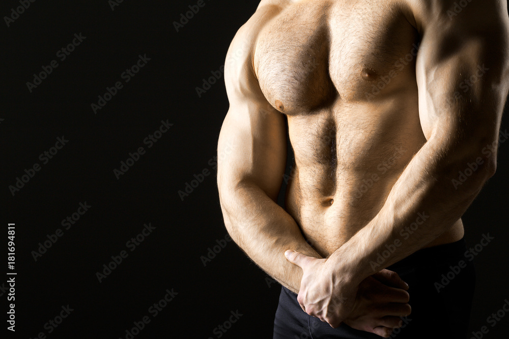 Powerful muscular man holding metal workout weight