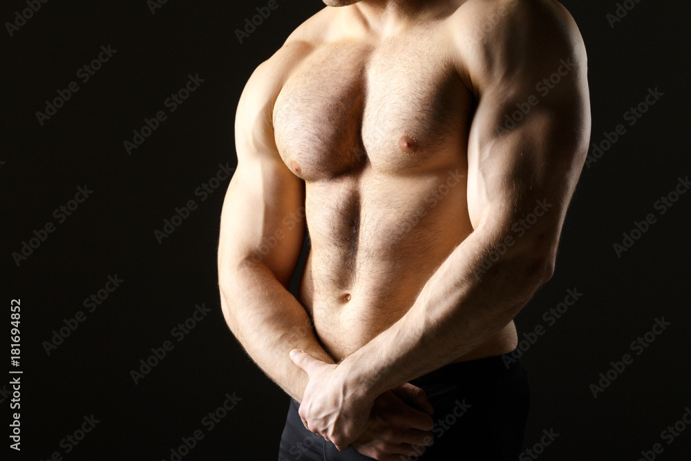 Powerful muscular man holding metal workout weight Powerful muscular man holding metal workout weight