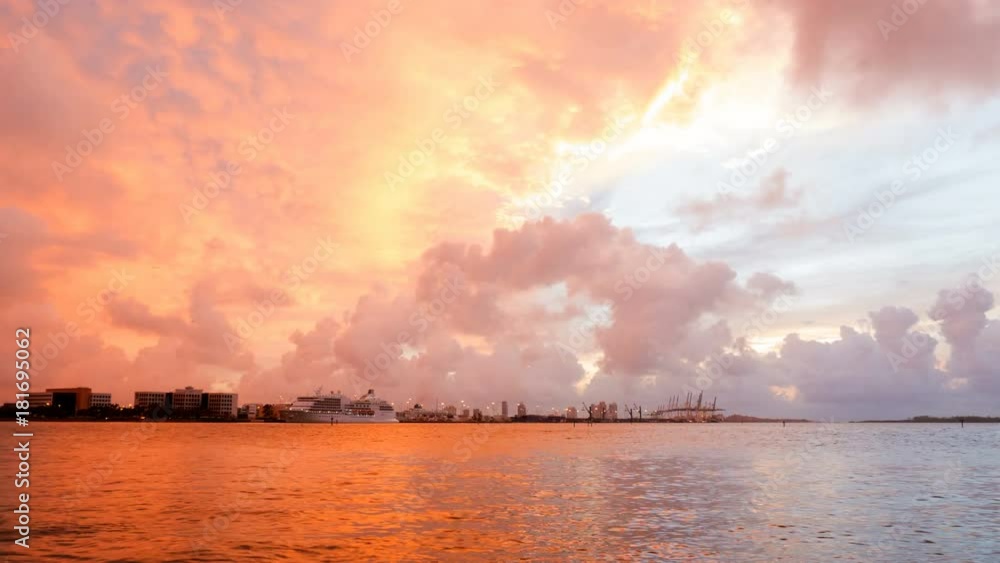 Time-lapse of Aerial Drone View Of Miami Loading Cranes By The Ocean With Ominous Clouds With The Sunrise Peeking Through Time-lapse of Aerial Drone View Of Miami Loading Cranes By The Ocean With Ominous Clouds With The Sunrise Peeking Through