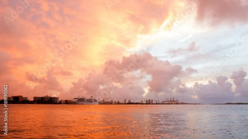Time-lapse of Aerial Drone View Of Miami Loading Cranes By The Ocean With Ominous Clouds With The Sunrise Peeking Through