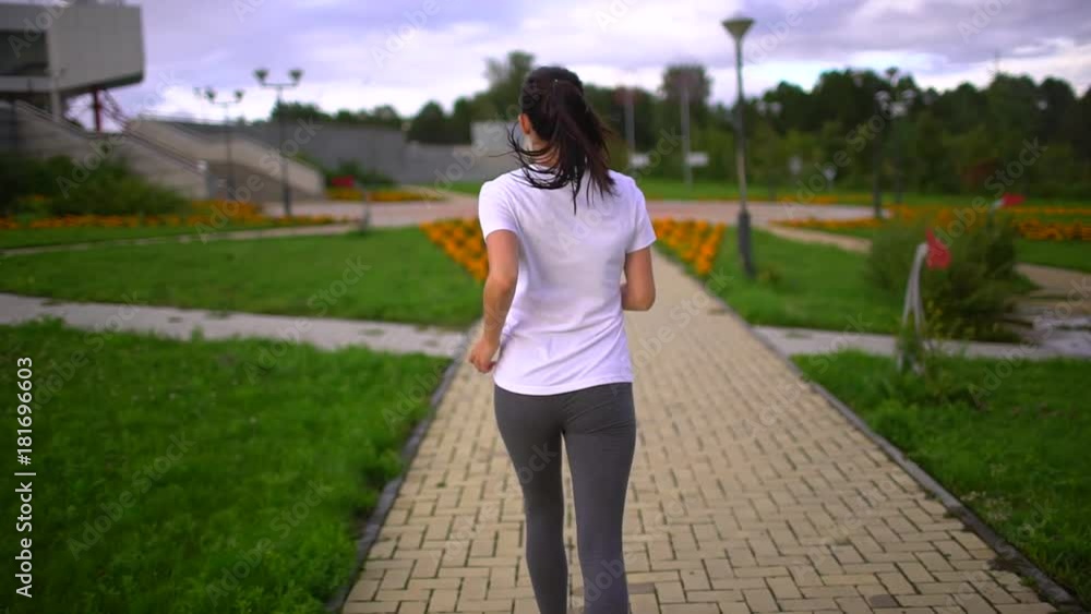 Young beautiful woman is running in the Park. slow-motion Young beautiful woman is running in the Park. slow-motion