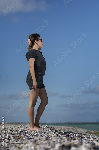 Beautiful young woman enjoying nature by the sea