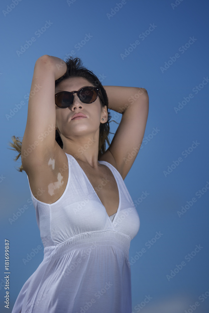 Beautiful young woman enjoying nature by the sea Beautiful young woman enjoying nature by the sea