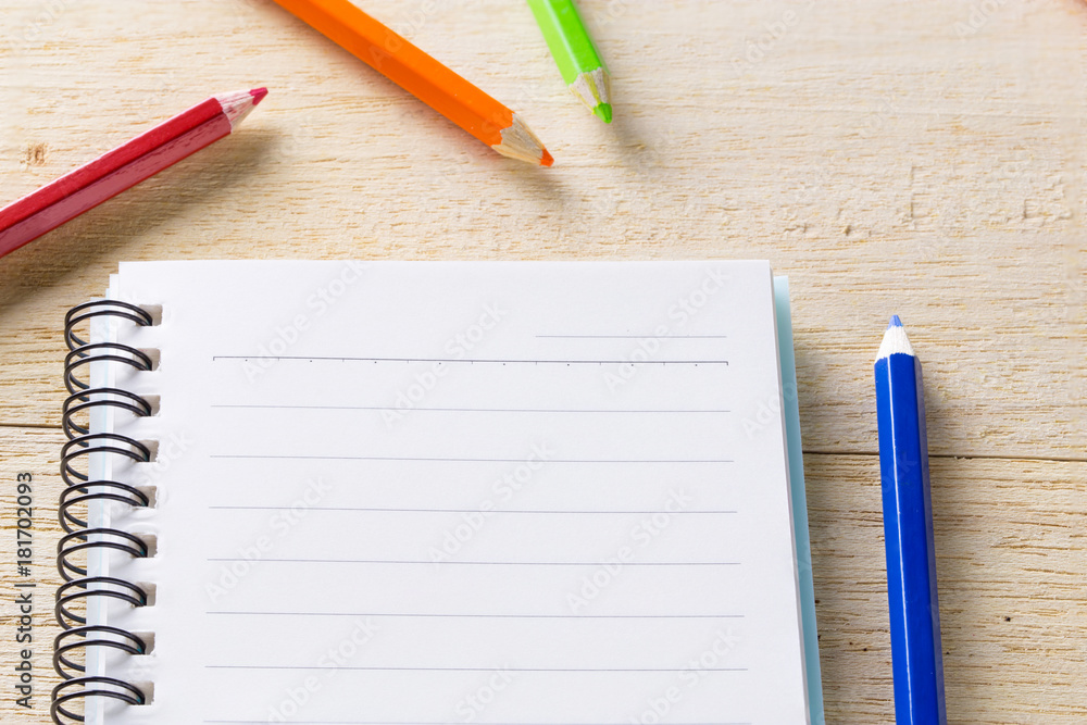book, diary and crayon on table book, diary and crayon on table