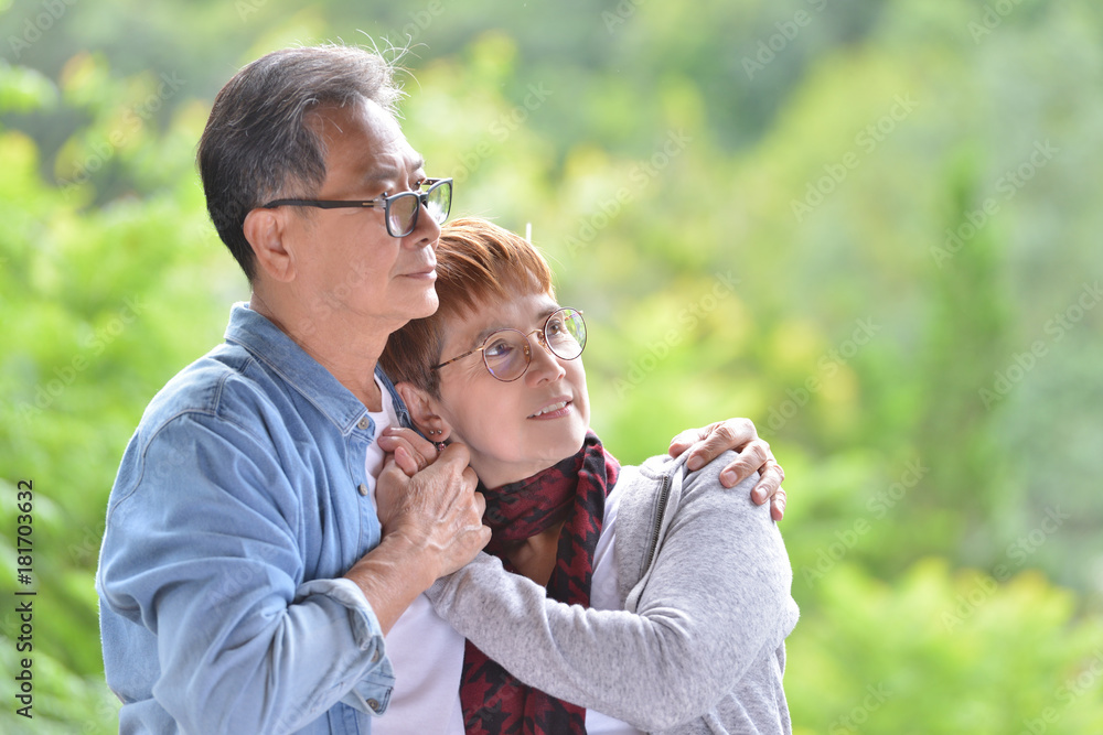 Fototapeta premium Portrait of happy romantic senior couple outdoor at the green nature background