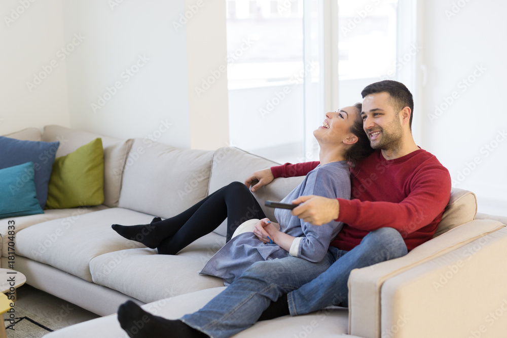 Young couple on the sofa watching television