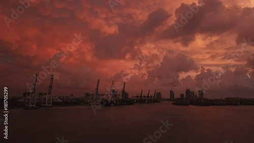 An Amazing Sunrise Where The Sky Turned Red. Over Looking Miami Loading Cranes With Stacks Of Containers and NO! The Red Sky Is Not Manipulated To Look Like This. End Of The World