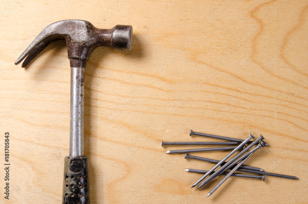 Hammer and nails in the background of plywood Hammer and nails in the background of plywood