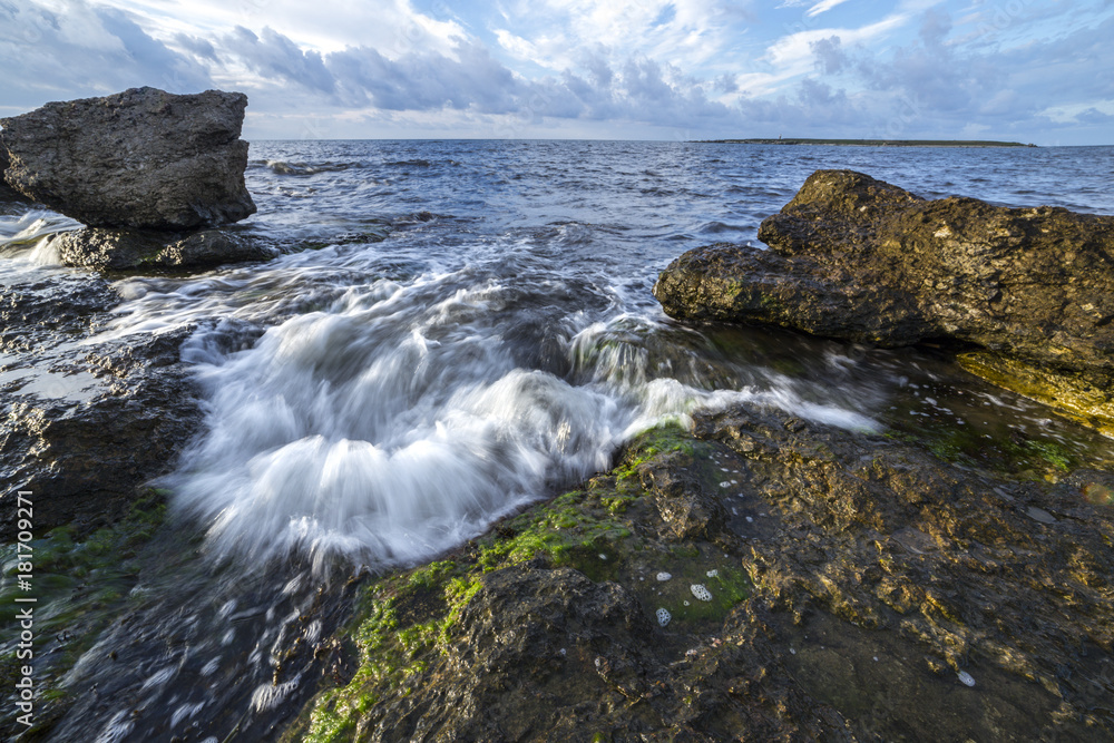Sea waters pushed by waves between rocks
