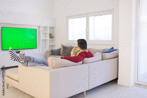 Young couple on the sofa watching television