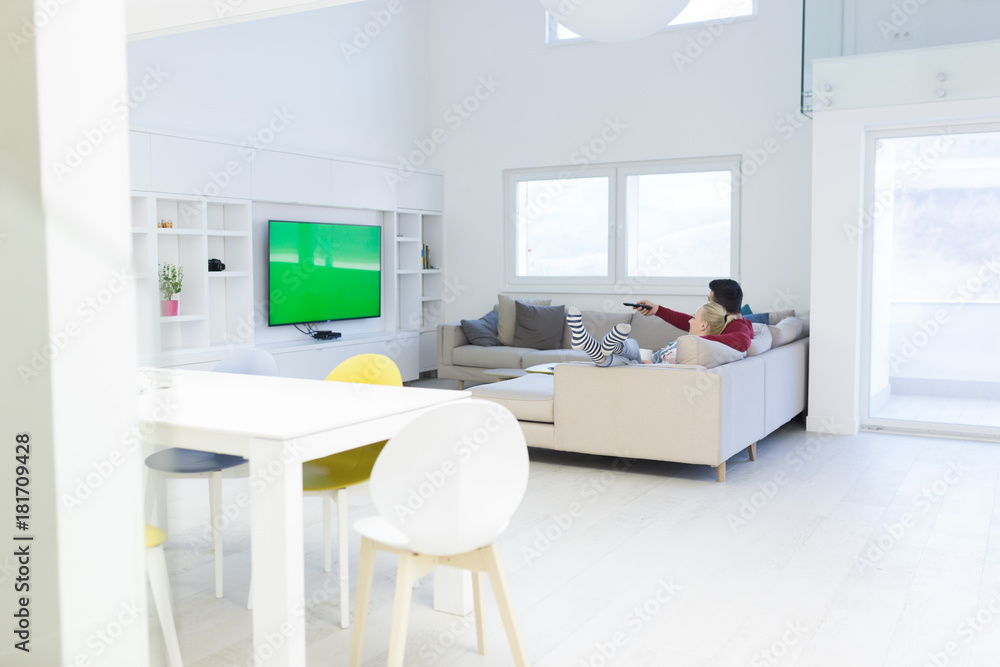 Young couple on the sofa watching television