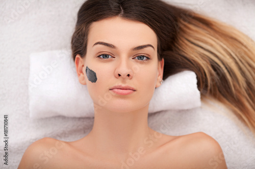 Facial Skin Care. Beautiful Woman Getting Cosmetic Mask In Salon
