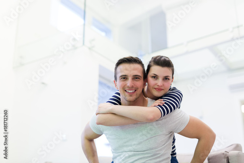 handsome man piggybacking his girlfriend